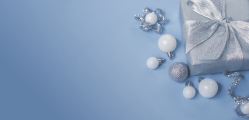 Silver gold Christmas gifts with snow background. silver decorations on pastel silver background. Flat lay, top view, Presents for Birthdays. Box with gifts tied with ribbon and bows. happy new year