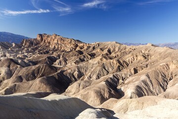 Fototapeta na wymiar Scenic Landscape View of Eroded Rock Formations and Blue Skyline at Famous Zabriskie Point, Death Valley National Park California USA 