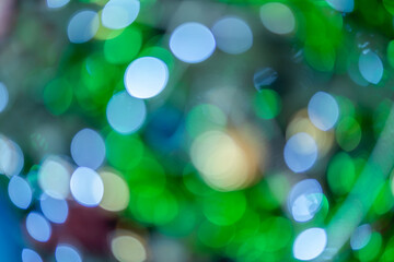 Merry x-mas,light Abstract circular bokeh of and Christmas greeting picture parcel decoration on Green Christmas tree background Decoration During Christmas and New Year.