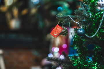 Merry x-mas,Close up of Colorful balls ,gifts box and Christmas greeting picture parcel decoration on Green Christmas tree background Decoration During Christmas and New Year.