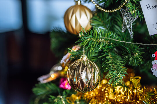 Merry x-mas,Close up of Colorful balls ,gifts box and Christmas greeting picture parcel decoration on Green Christmas tree background Decoration During Christmas and New Year.