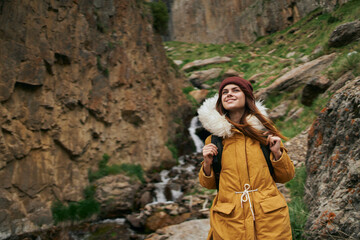 Naklejka na ściany i meble woman hiker with backpack mountains travel adventure freedom