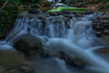 Naklejka na ściany i meble Kathu waterfall water gently flowing down the rocks Patong Phuket Thailand Asia