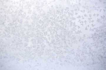 Ice patterns on winter glass. Abstract white background, wallpaper.