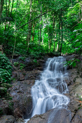 Fototapeta premium Kathu waterfall water gently flowing down the rocks Patong Phuket Thailand Asia
