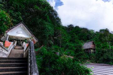 Timber hut in Kathu forest near water fall district mountains surrounded by lush green trees Phuket Thailand