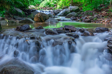 Naklejka na ściany i meble Kathu waterfall water gently flowing down the rocks Patong Phuket Thailand Asia