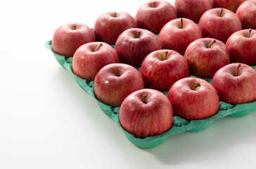 Apples neatly laid out in a paper case.