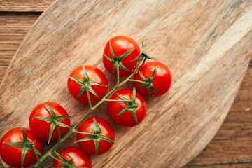 cherry tomatoes on a branch on a wooden board kitchen ingredient fresh food