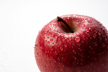 Closeup of apples with water drops on white background.