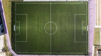 Aerial view of green football, soccer pitch. Top down view on a green, empty soccer field © dechevm