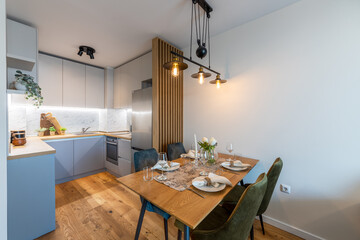 New modern kitchen with table served for dinner. New home. Interior photography.