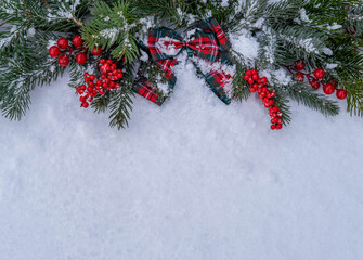 Fototapeta na wymiar Merry Christmas and Happy New Year. Christmas background with toys and branches of fir trees in the snow. New Year's card. Background with space to copy.