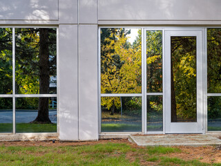 Autumn foliage reflected in the lower windows of a modern office