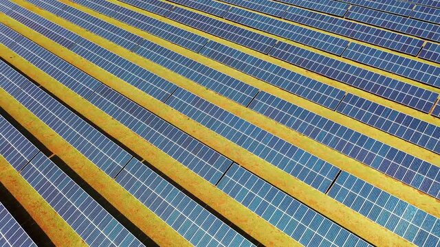 Photovoltaic solar panels farm. Green energy generation. Solar panels field at countryside. Cleaning energy for control of climate change. Environment emissions reduction. 
