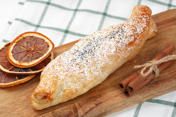 Traditional apple strudel on wooden board, close up