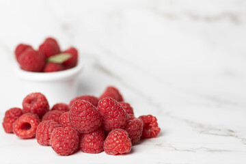 raspberries on white background. copy space. selective focus