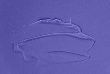 Liquid gel cosmetic product with shimmery particles and bubbles on purple background. Texture and background. Color of the Year 2022