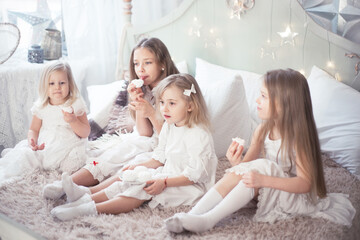 Girls sisters or friends eat sweets in the morning in the bedroom.