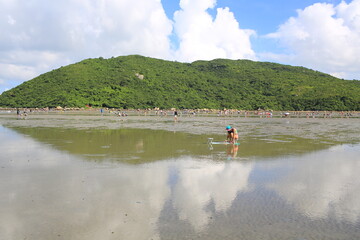 Fototapeta na wymiar sea tide back and shadow water, reflect the cloudy sky in Lantau island, Shui Hau
