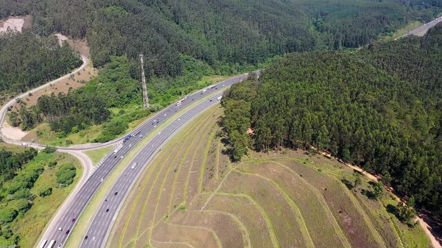 Aerial landscape of Bandeirantes highway road at countryside mountains. Landmark highway road between mountains. Rural landscape. Traffic at road. Scenic freeway road.
