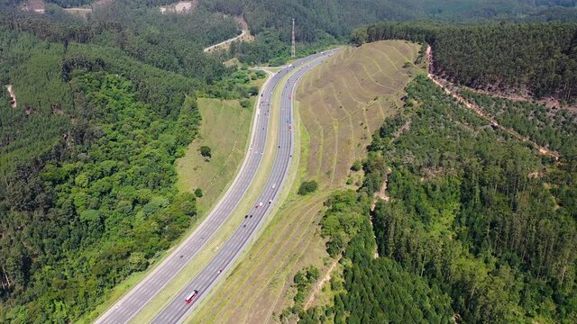Aerial landscape of Bandeirantes highway road at countryside mountains. Landmark highway road between mountains. Rural landscape. Traffic at road. Scenic freeway road.