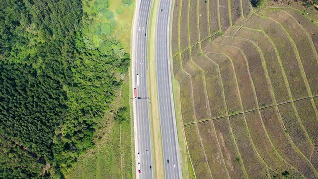 Aerial landscape of Bandeirantes highway road at countryside of Sao Paulo state Brazil. Landmark highway road between mountains. Rural landscape. Traffic at road. Brazilian freeway road.
