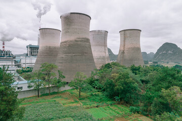 The cooling tower of the factory built next to the green space