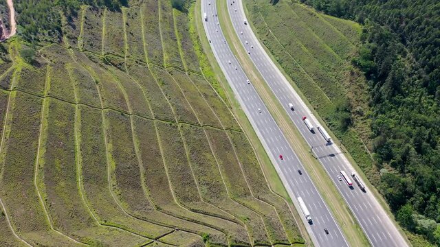 Aerial landscape of Bandeirantes highway road at countryside mountains. Landmark highway road between mountains. Rural landscape. Traffic at road. Scenic freeway road.