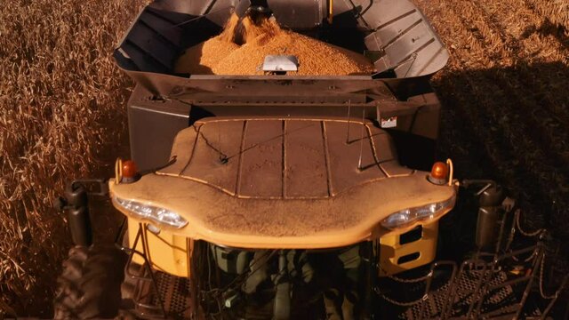 4K AERIAL FOOTAGE OF COMBINE OPERATION WITH SUPPORTING TRACTORS REAPING WEATH IN QUEBEC CANADA