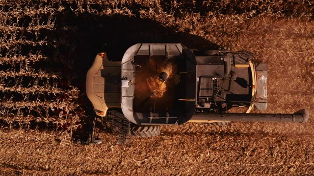 4K AERIAL FOOTAGE OF COMBINE OPERATION WITH SUPPORTING TRACTORS REAPING WEATH IN QUEBEC CANADA