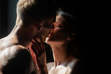 Closeup face of a beautiful young couple in love embracing, romance and and affection. Sensual couple in the tender passion.