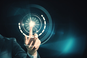 Close up of business man hand using abstract round interface on blue background. HUD, click, push screen and technology concept.
