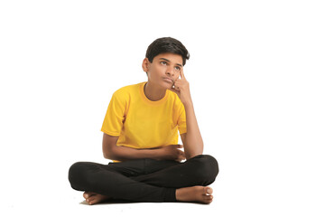 Indian boy thinking some idea on white background.