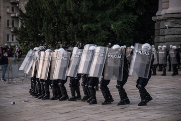 Police cordon with shields gathered in formation ready to defend the assemblies of the republic of...