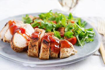 Roasted chicken fillet with salad  fresh tomatoes and arugula.