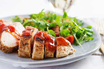 Roasted chicken fillet with salad  fresh tomatoes and arugula.