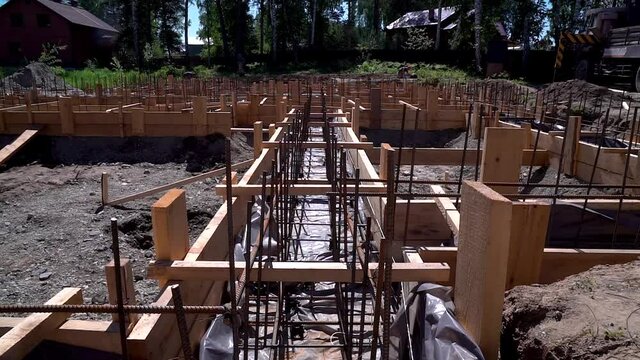 Pouring concrete. Pouring a concrete foundation on a construction site. Construction of a cottage.