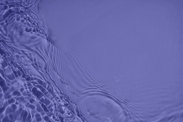 Transparent purple water surface texture with ripples, splashes and bubbles. Abstract nature...