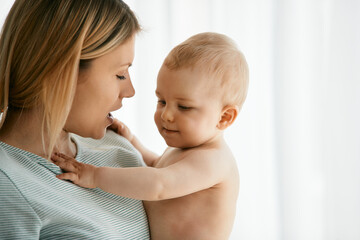 Young mother and her baby son at home.