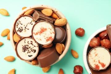 Concept of sweets with chocolate candies on mint background