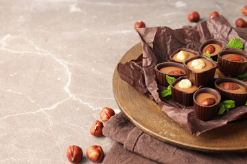 Concept of sweets with chocolate candies on textured background