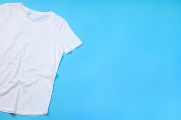 Blank white t-shirt with space for print on blue background