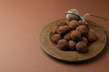 Concept of sweets with truffles on brown background