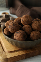 Concept of sweets with truffles on white wooden table