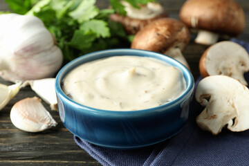 Concept of tasty food with mushroom sauce on wooden background