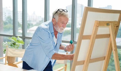 Senior man art paint working with happy in modern room.