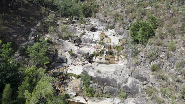 Visitors at Fecha de Barjas waterfall, Peneda-Ger&ecirc;s National Park. Aerial pullback
