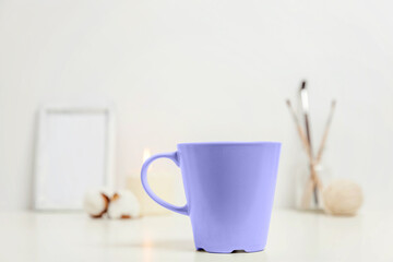 Interior decoration with hot drink mug cup coffee colored in trendy color of year 2022 Very Peri, white background isolated. Inspired by using color 17-3938, Color of the year concept.