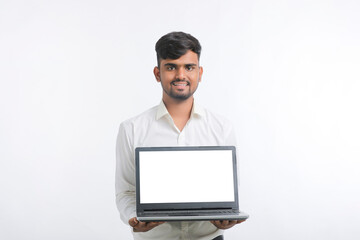 Young indian man showing laptop screen with copy space on white background.